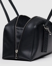 Black leather bag with a zipper on a light gray background