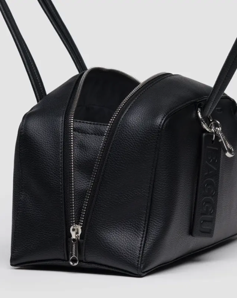 Black leather bag with a zipper on a light gray background