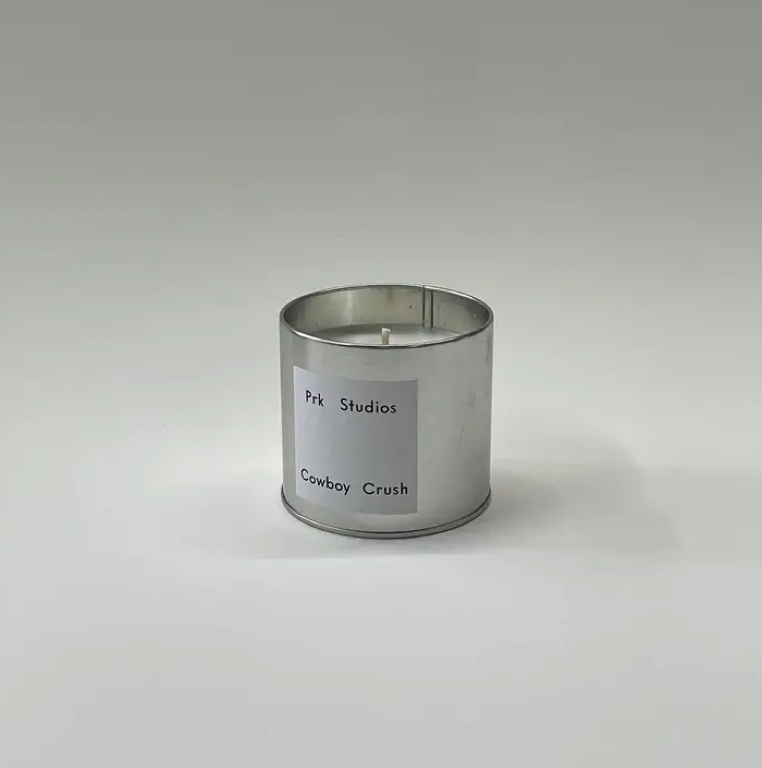 Soy Candle in a metal silver tin labeled Prk Studios 'Cowboy Crush' on a gray background