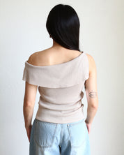 Woman wearing a beige Ribbed Off Shoulder Sleeveless Top and light blue jeans