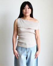 Woman wearing a beige Ribbed Off Shoulder Sleeveless Top and light blue jeans