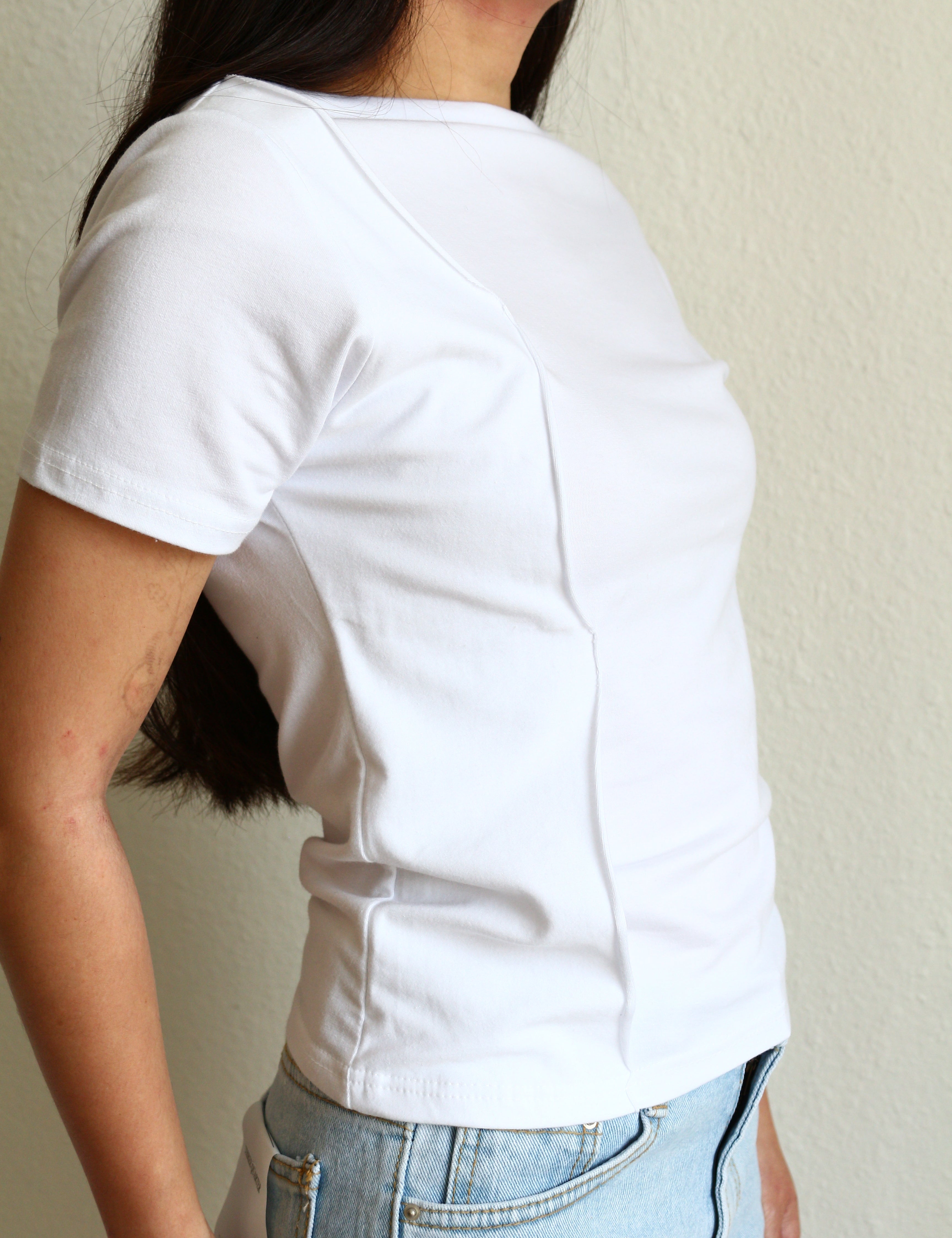 Model wearing a white Wavy Boat Neck Off Shoulder Tee