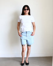 Model wearing a white Wavy Boat Neck Off Shoulder Tee