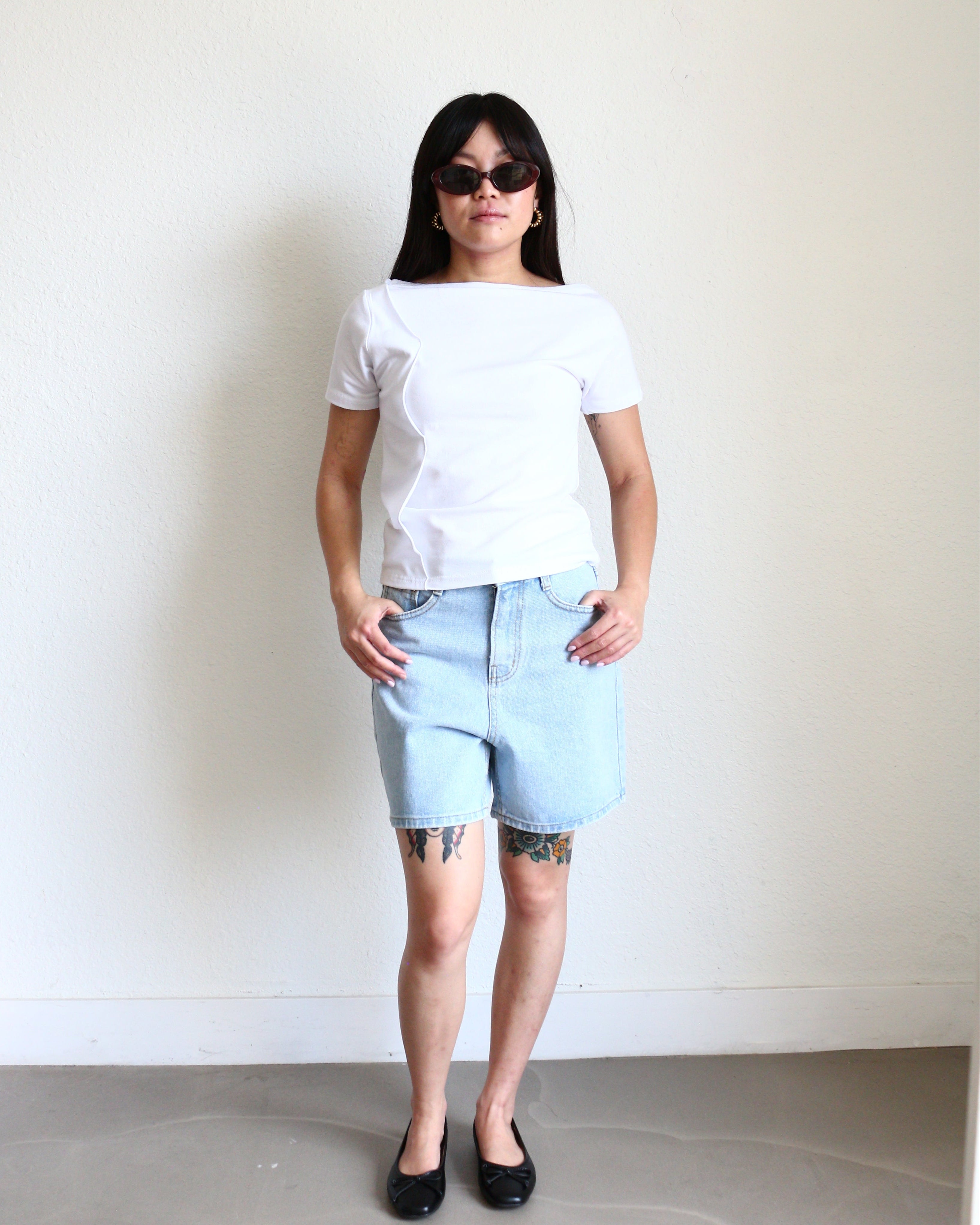 Model wearing a white Wavy Boat Neck Off Shoulder Tee