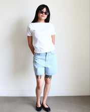 Model wearing a white Wavy Boat Neck Off Shoulder Tee