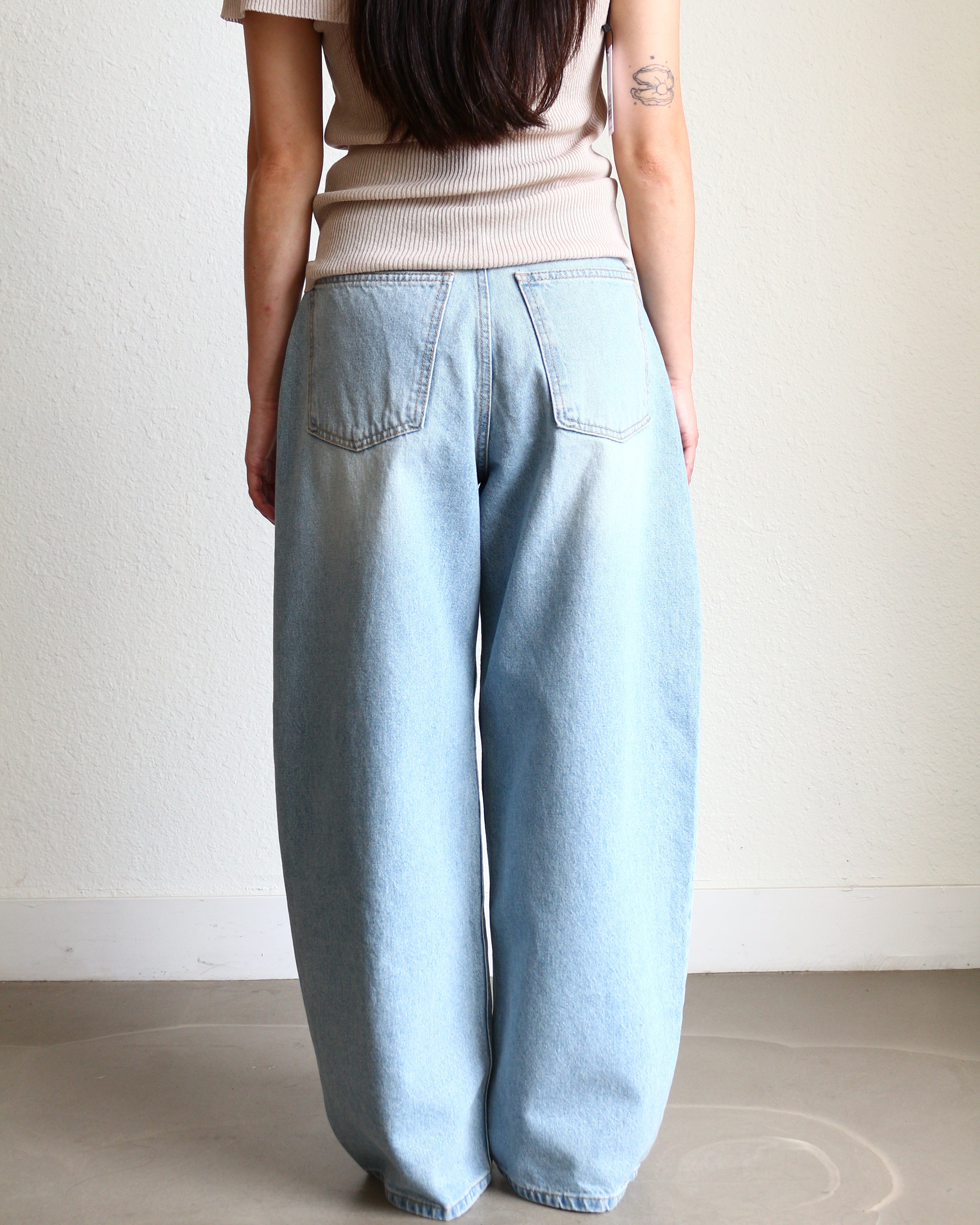 Light blue jeans Wide Barrel Denim - Light Wash wearing black ballet flats and cream ribbed top