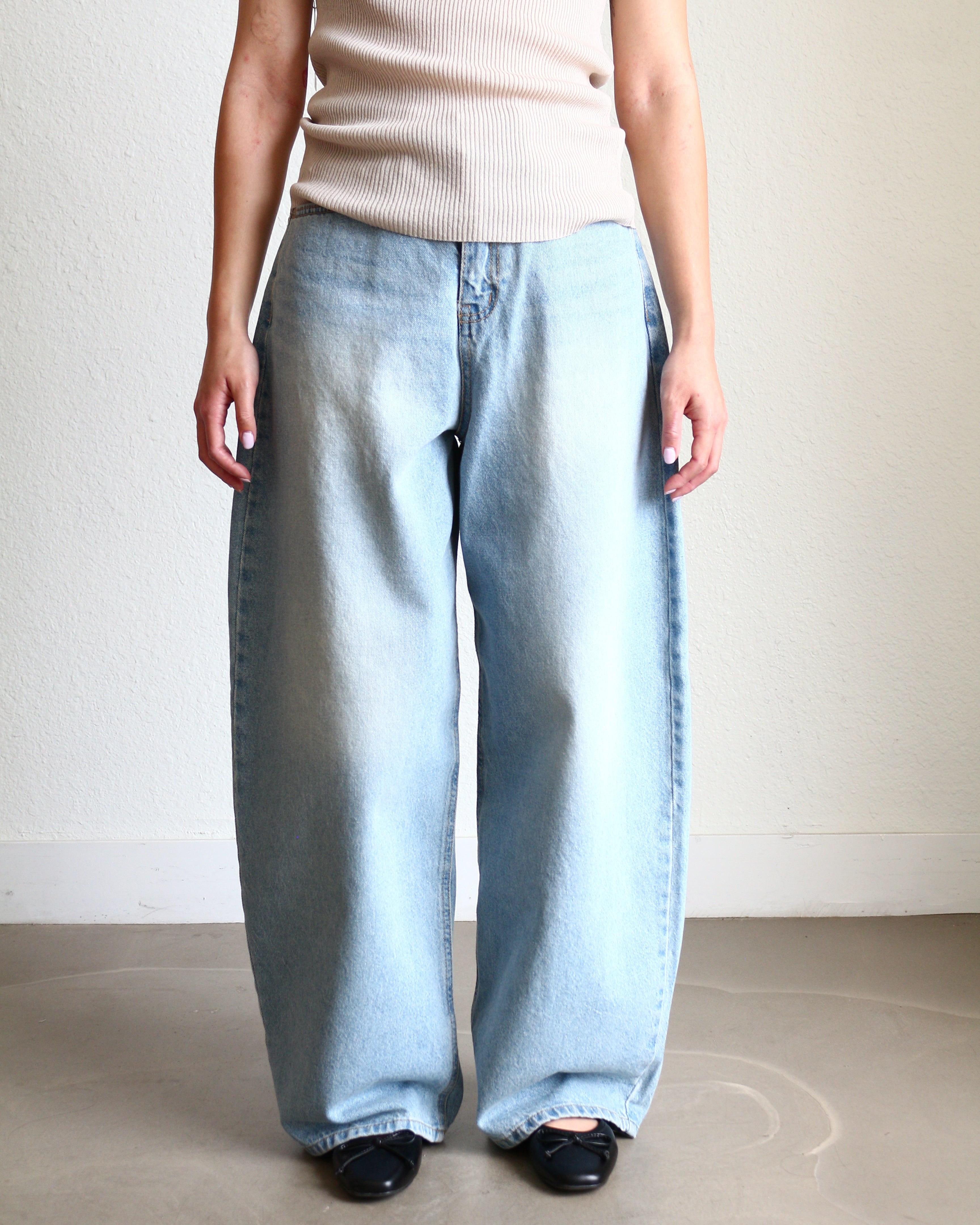 Light blue jeans Wide Barrel Denim - Light Wash wearing black ballet flats and cream ribbed top