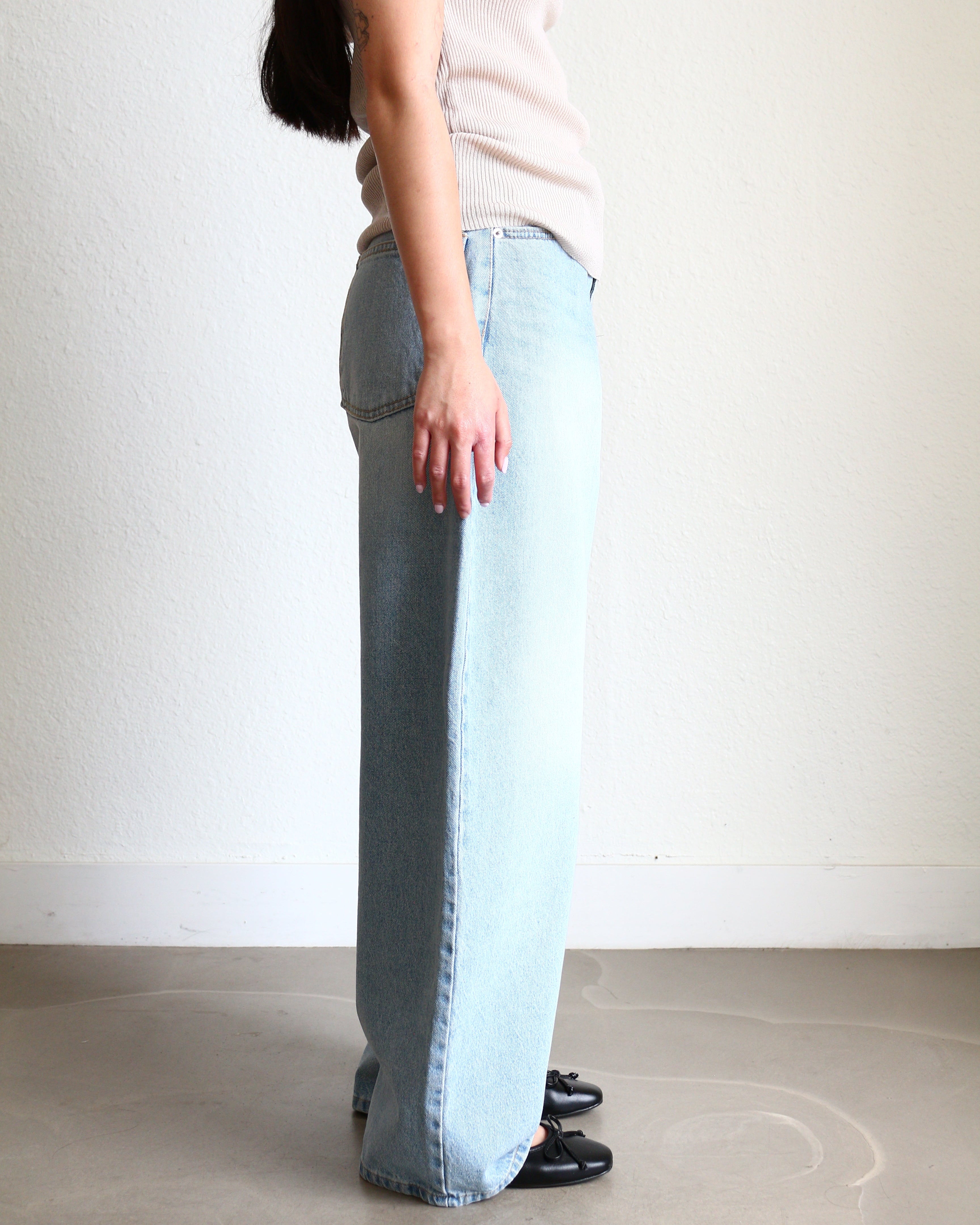 Light blue jeans Wide Barrel Denim - Light Wash wearing black ballet flats and cream ribbed top