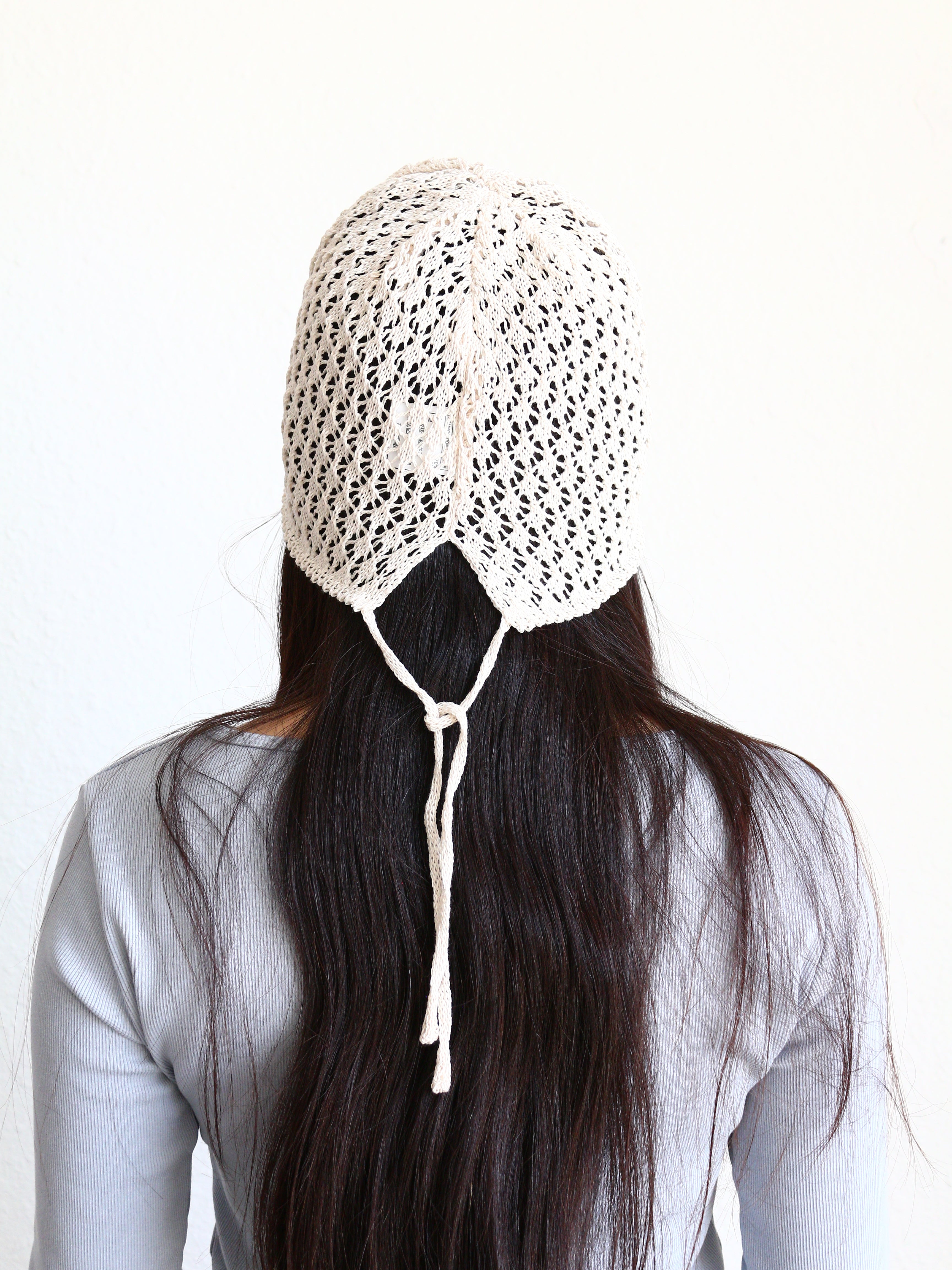Behind Close-up of with a white crochet boho bucket cap