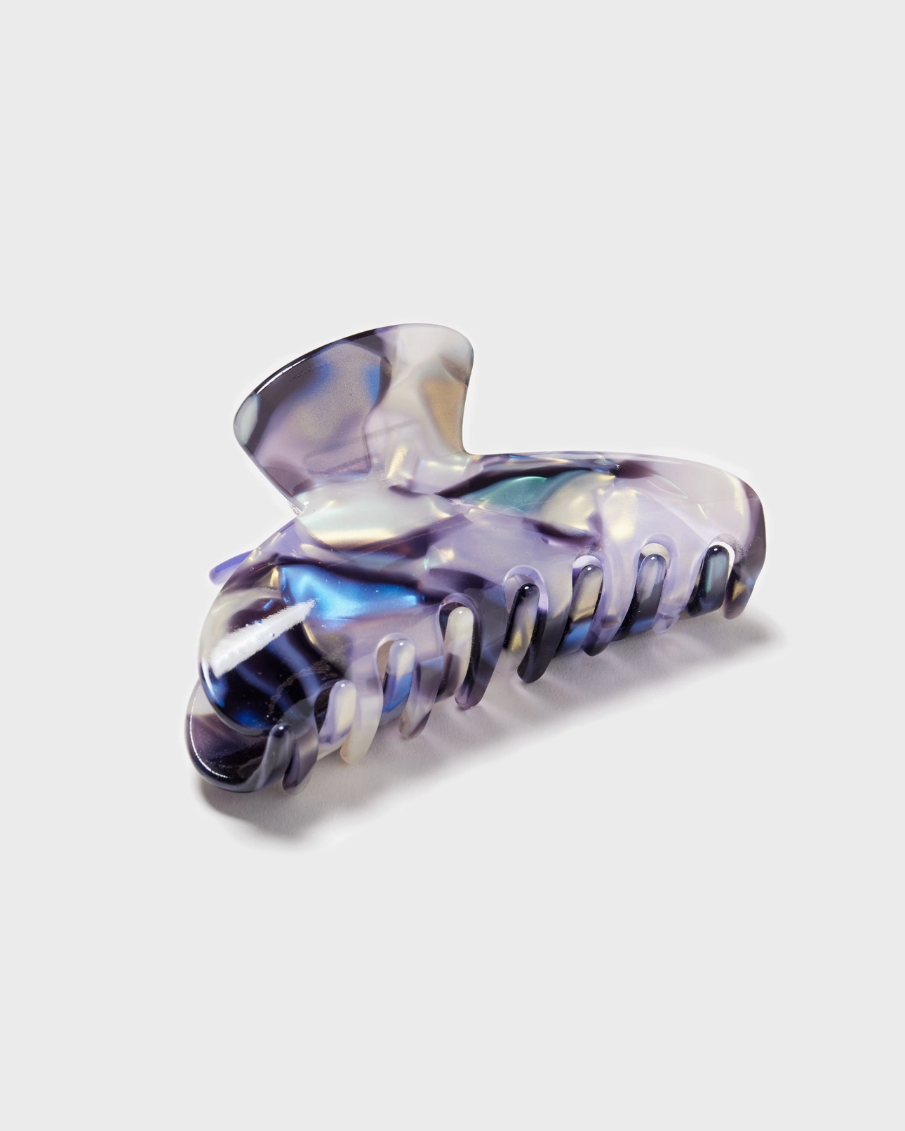 Translucent purple hair clip on a light gray background