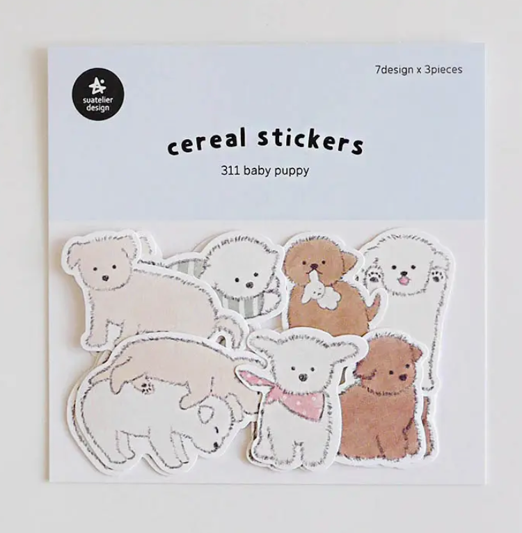 Packaging of cereal stickers featuring baby puppies on a light background