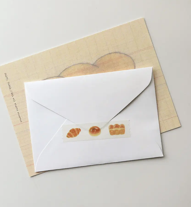 White envelope with bread illustrations on a beige background
