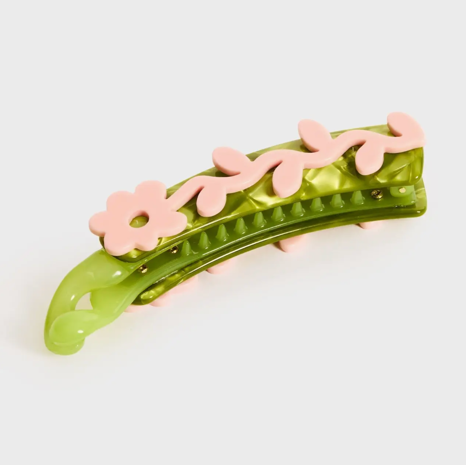 Green hair clip with pink floral decorations on a white background