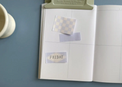 Open notebook with stickers on a blue surface