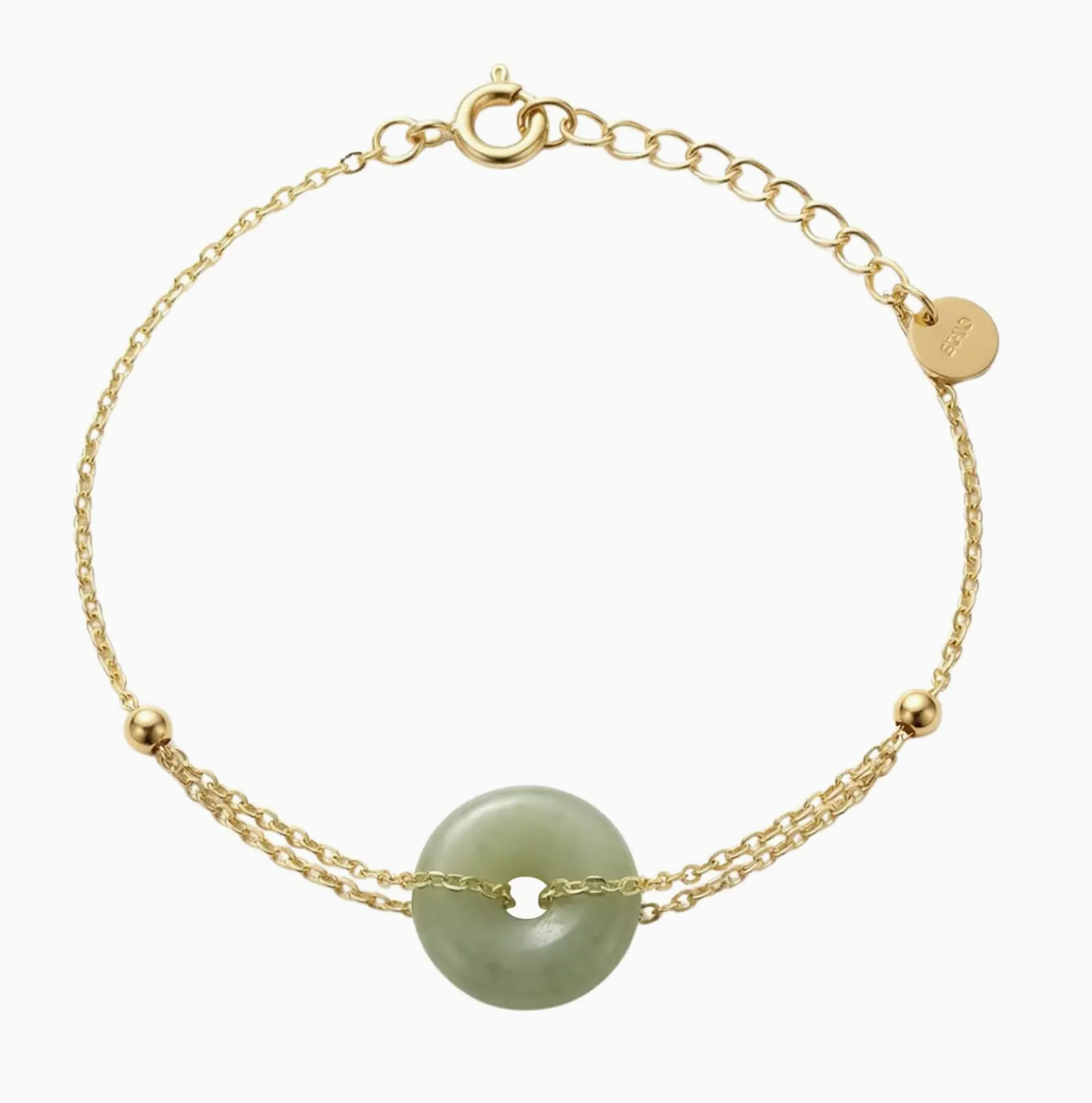 Gold bracelet with a green stone on a white background