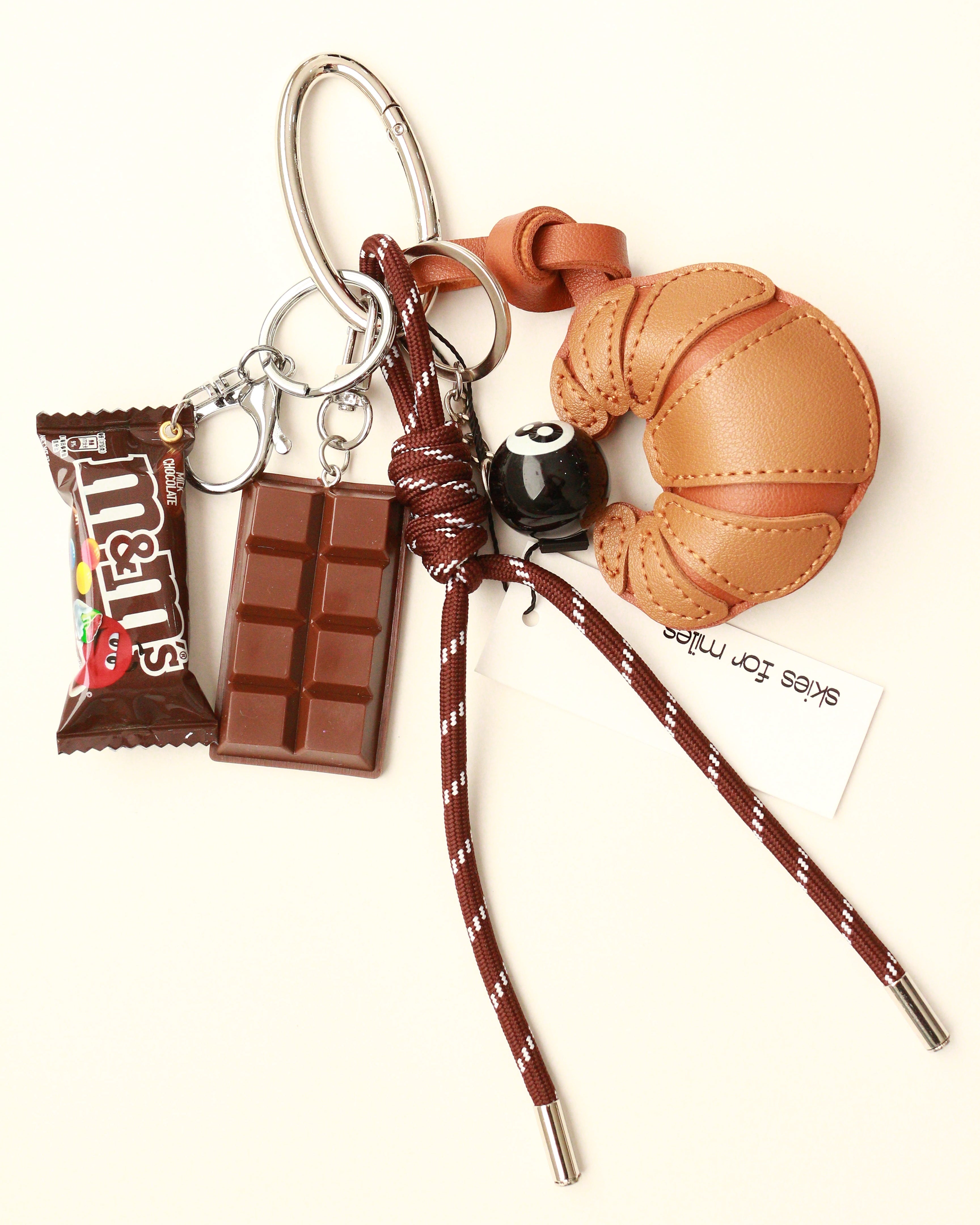 Keychain with a small brown bag and chocolate bar on a white background