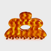 Tortoiseshell patterned hair claw on a light gray background
