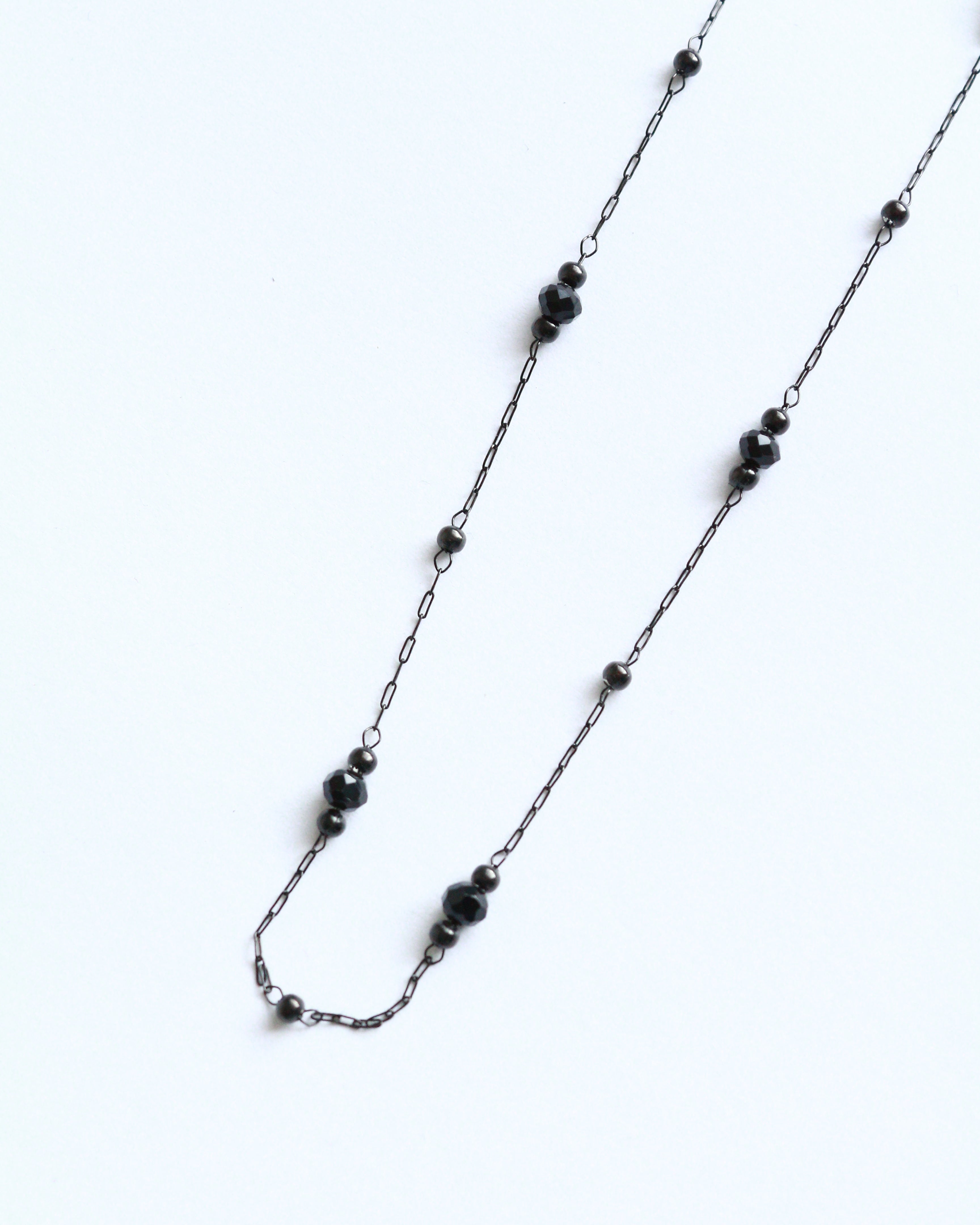 Necklace with black beads on a white background