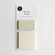Two sticky notes with different designs on a white background