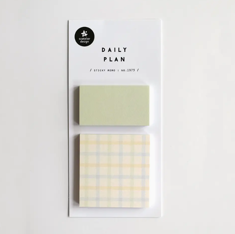 Two sticky notes with different designs on a white background