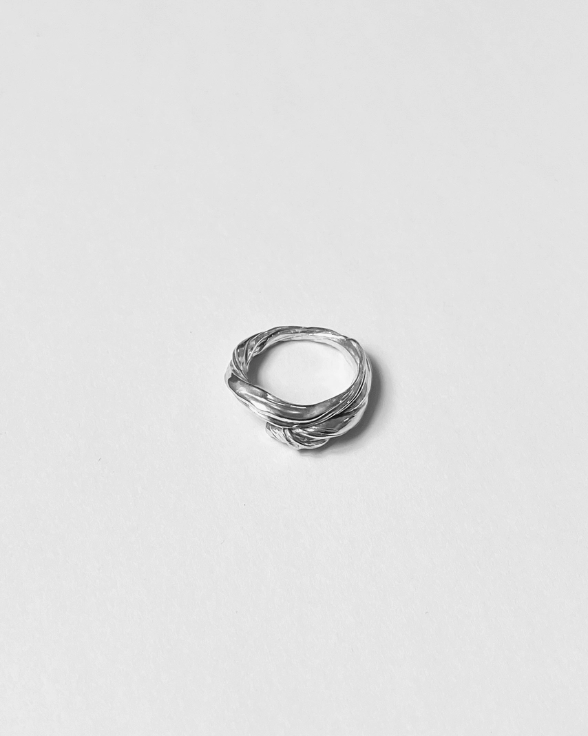 Silver ring on a light gray background