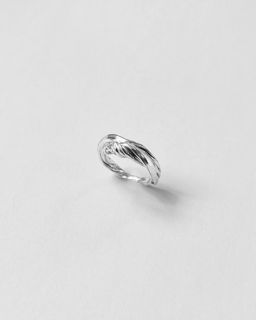 Silver ring on a light gray background