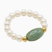 Pearl bracelet with a green stone and gold beads on a white background