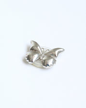Silver brooch on a white background