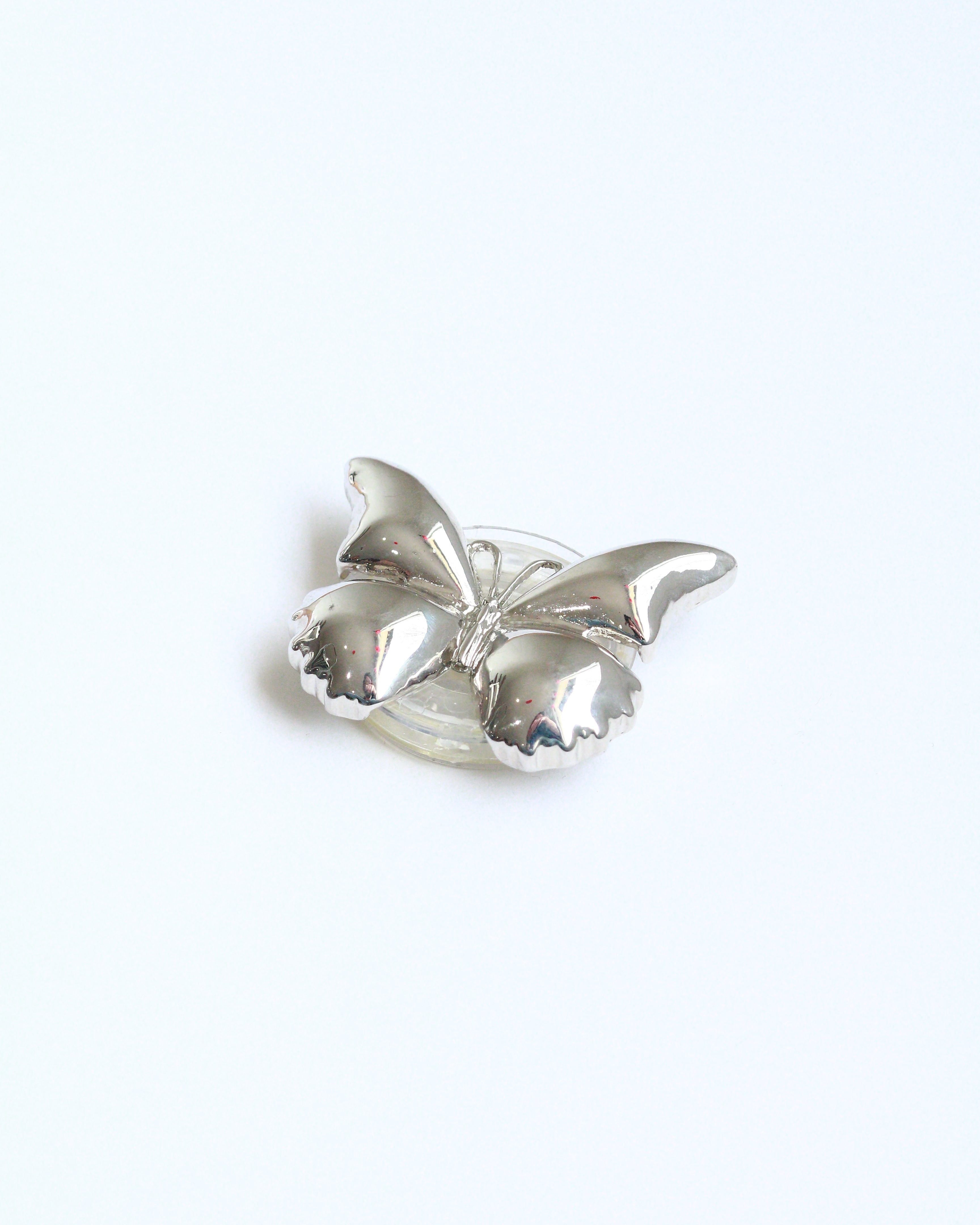 Silver brooch on a white background
