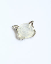 Silver pendant with a clear stone on a white background