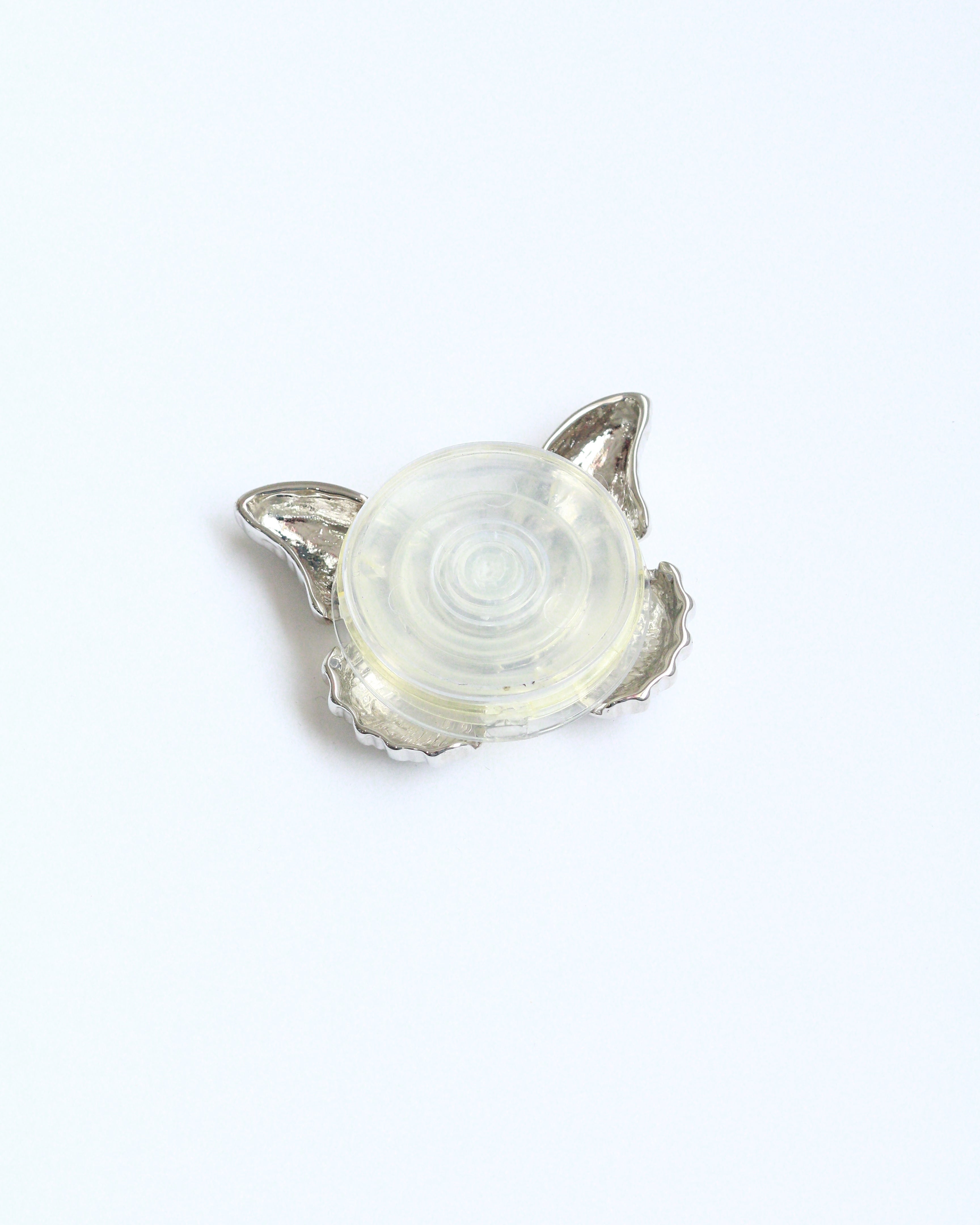 Silver pendant with a clear stone on a white background