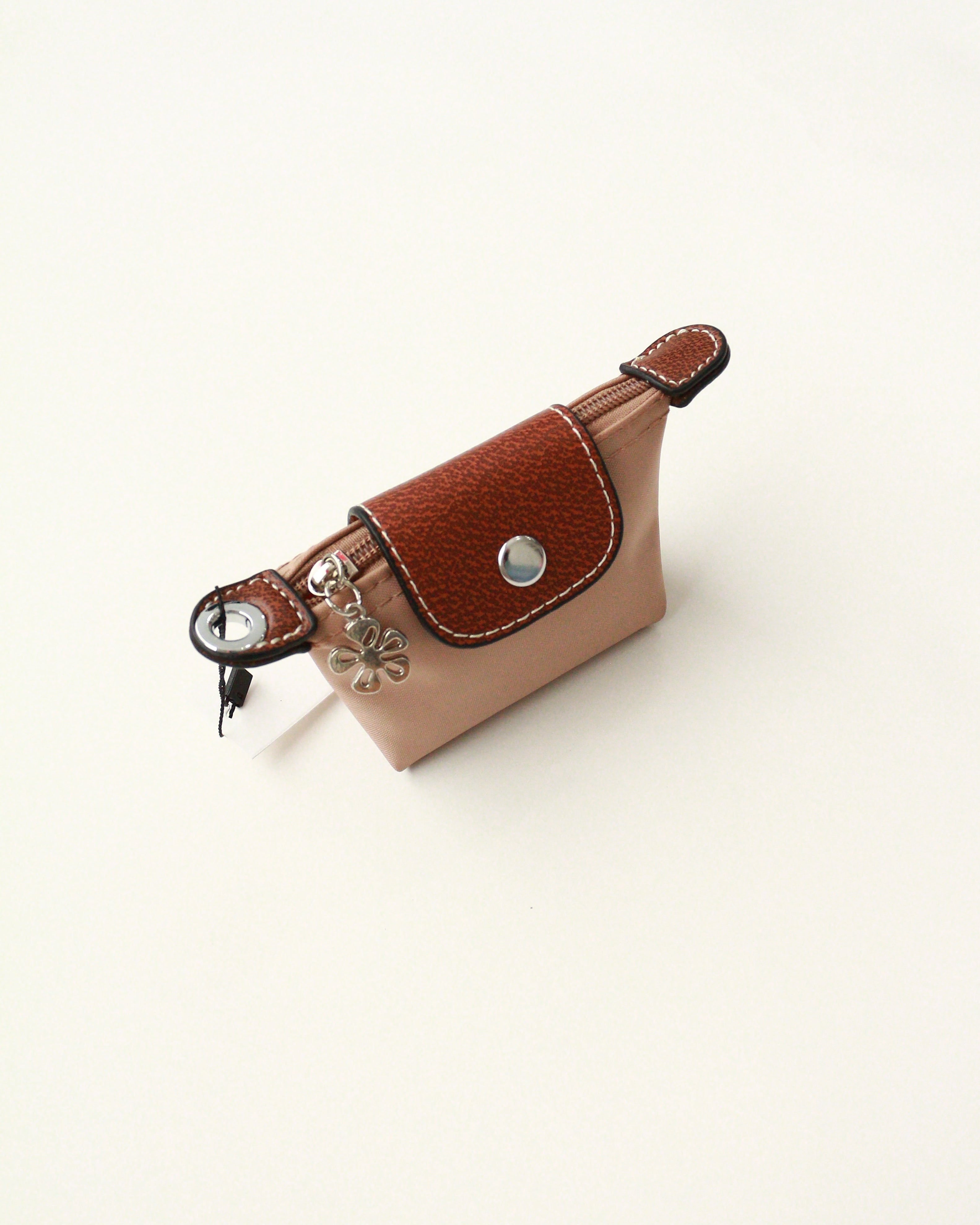 Brown leather keychain with decorative elements on a white background
