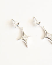 Decorative wall sconce with a white finish on a white background
