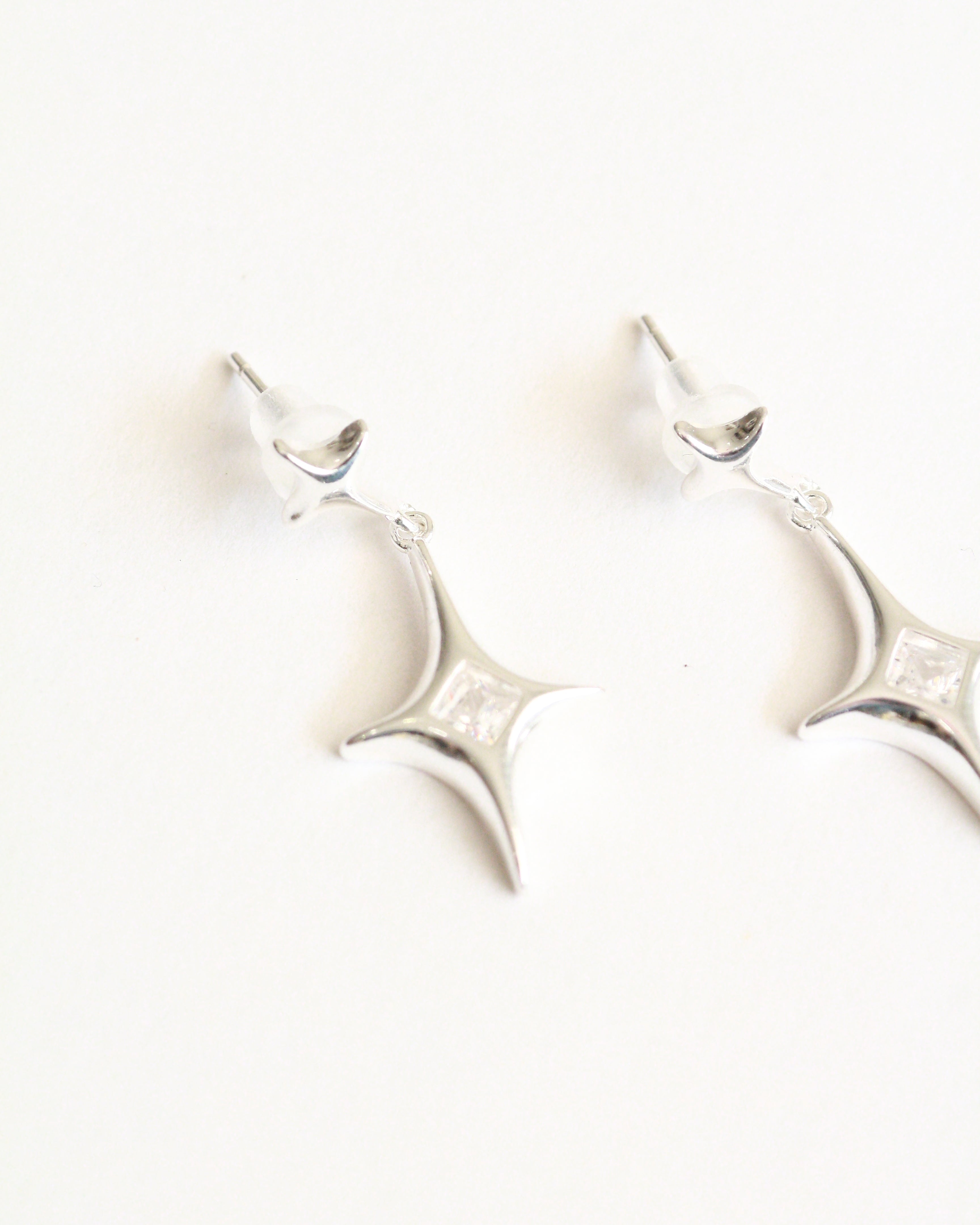Decorative wall sconce with a white finish on a white background
