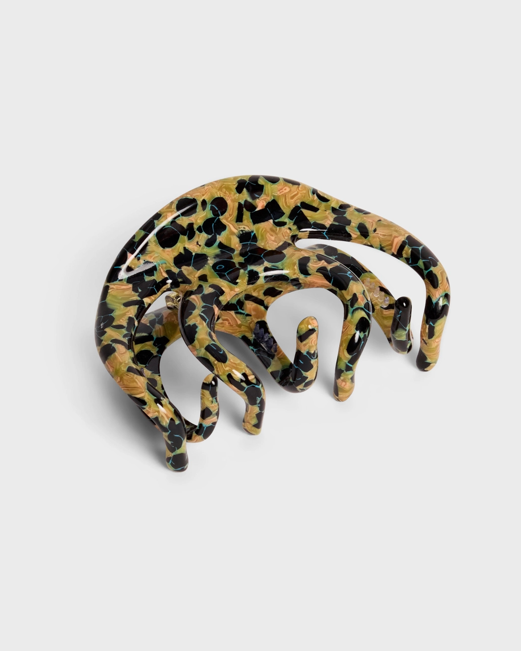 Leopard print hair comb on a white background
