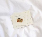 Set of three small envelopes with a house illustration on a white fabric background