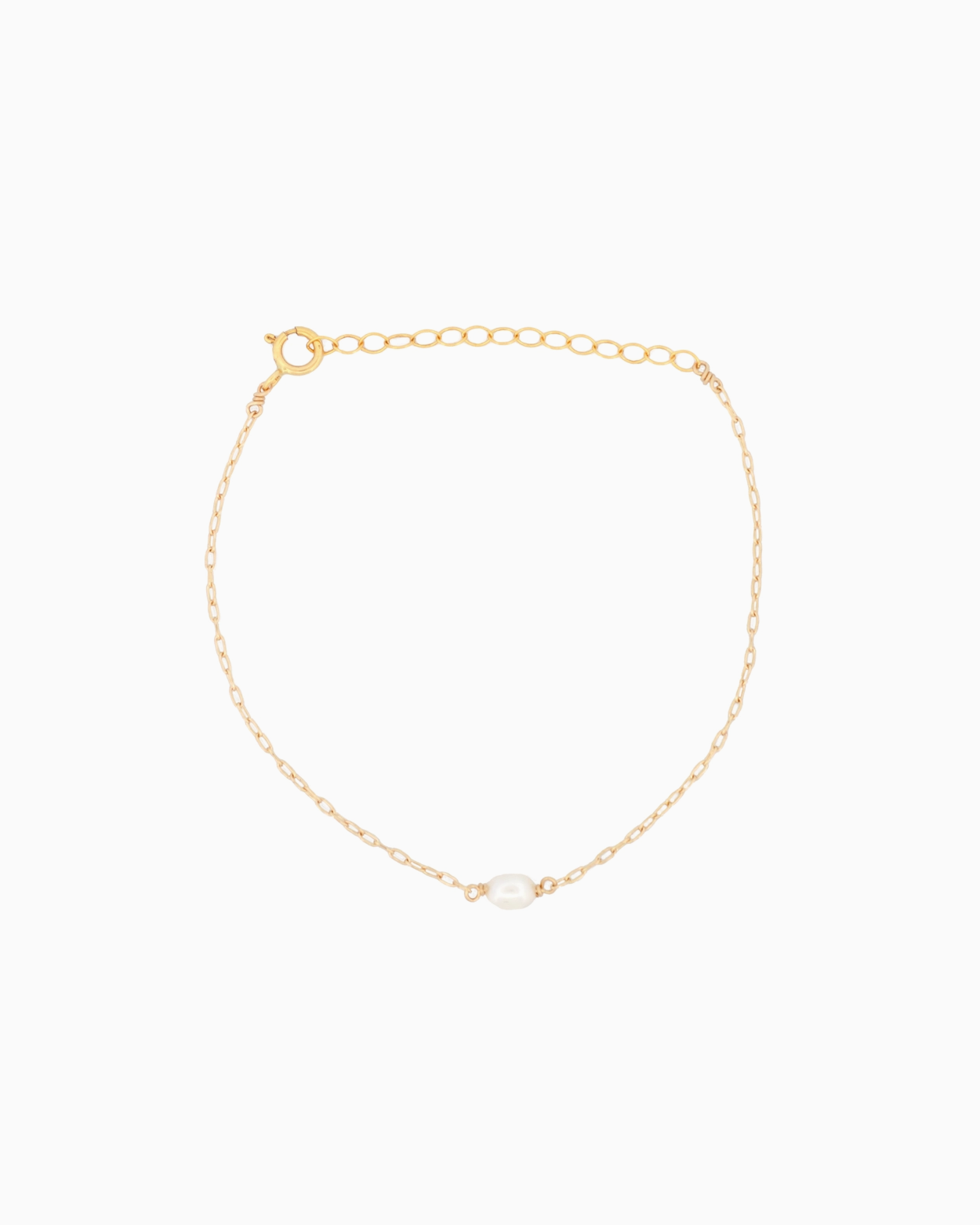 Gold bracelet with a pearl on a white background