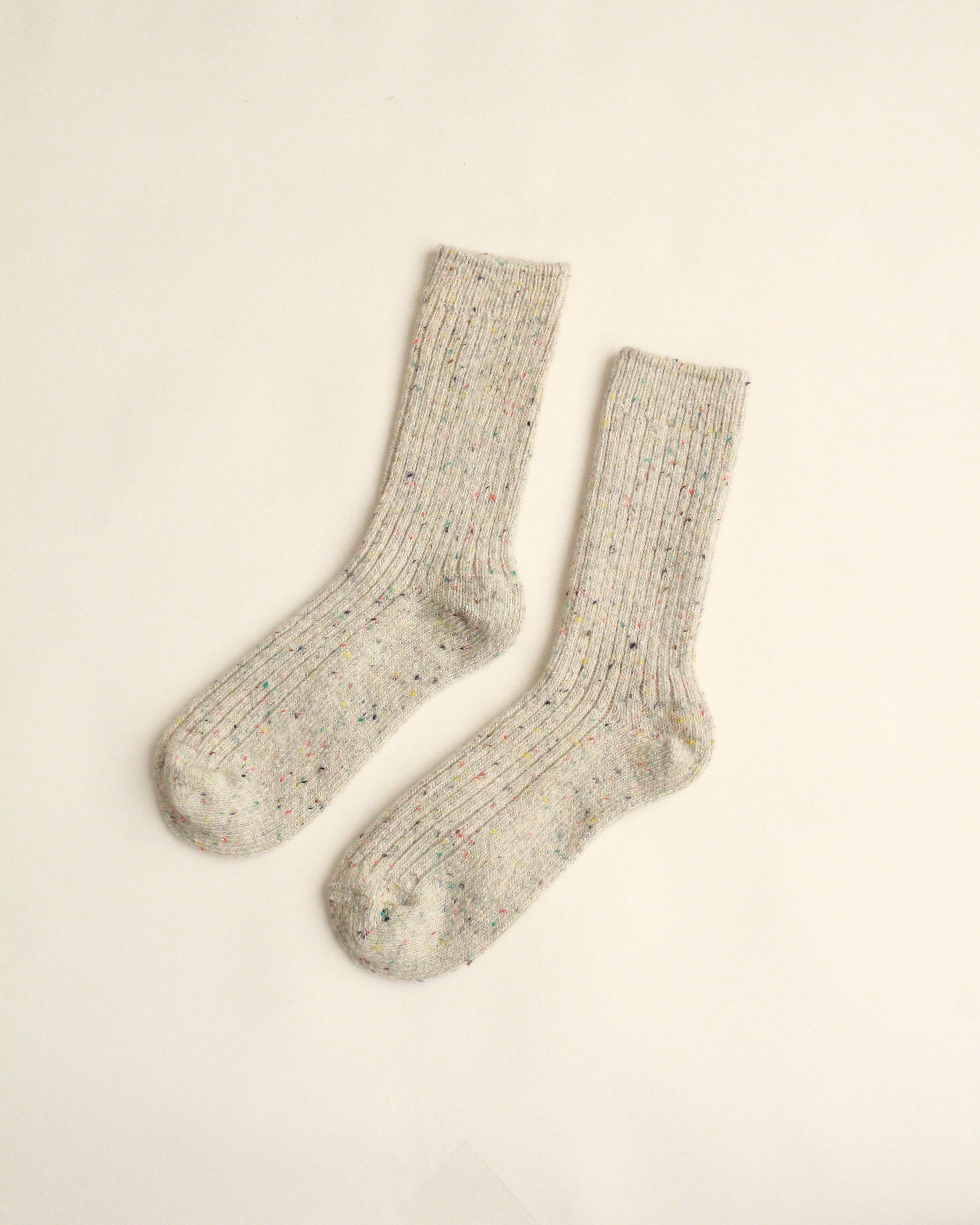 Pair of gray socks on a beige background
