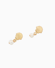 Gold shell and pearl earrings on a white background