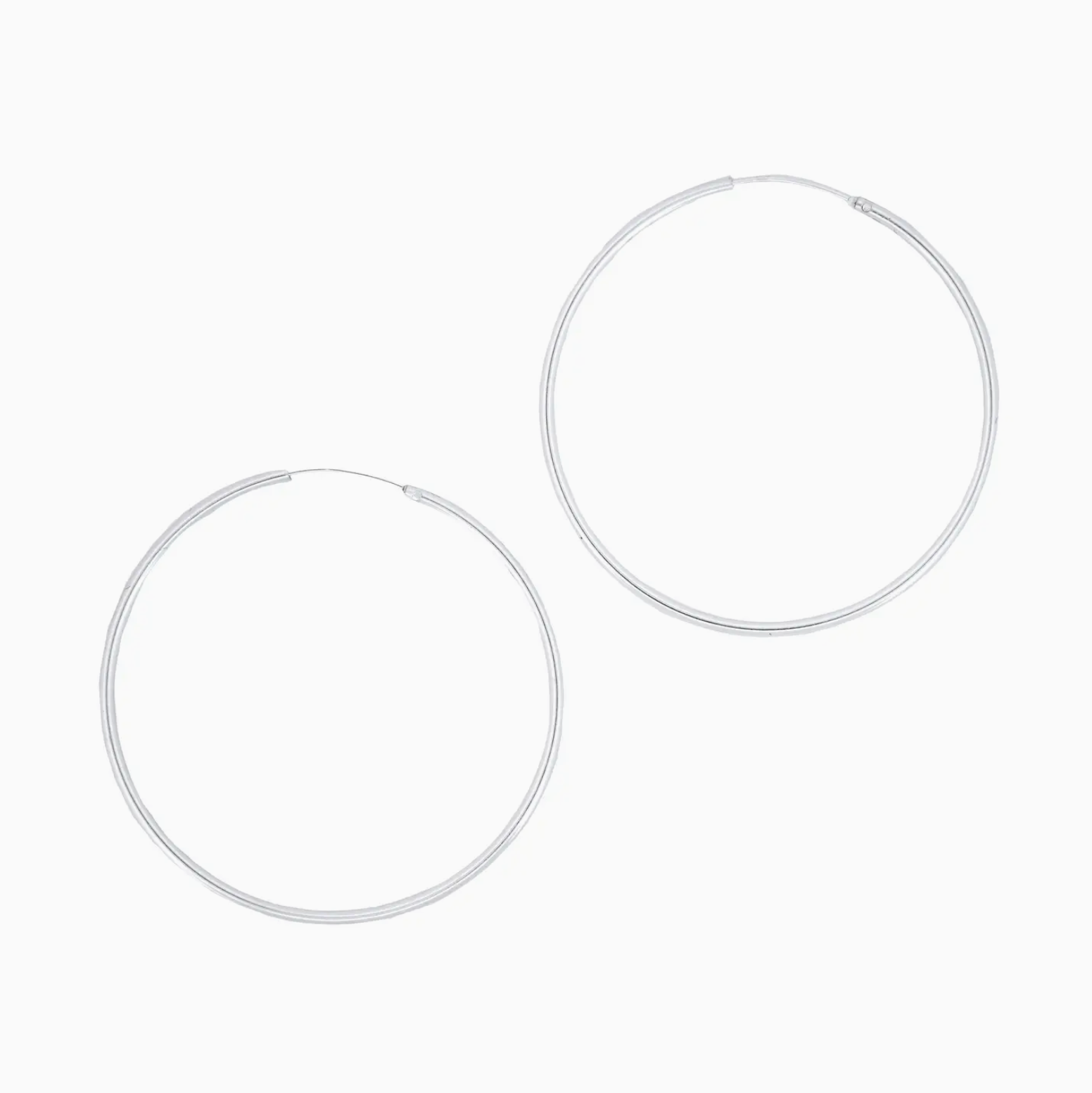 Pair of silver hoop earrings on a white background