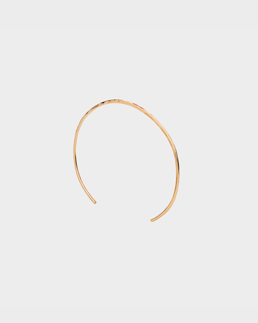 Gold headband on a light gray background