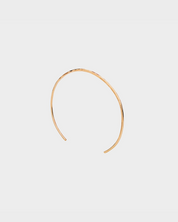 Gold headband on a light gray background