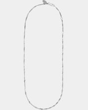 Silver necklace on a light gray background